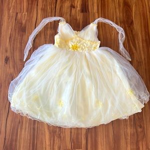 Cute yellow wedding or party dress with a bow in back and flowers in the front